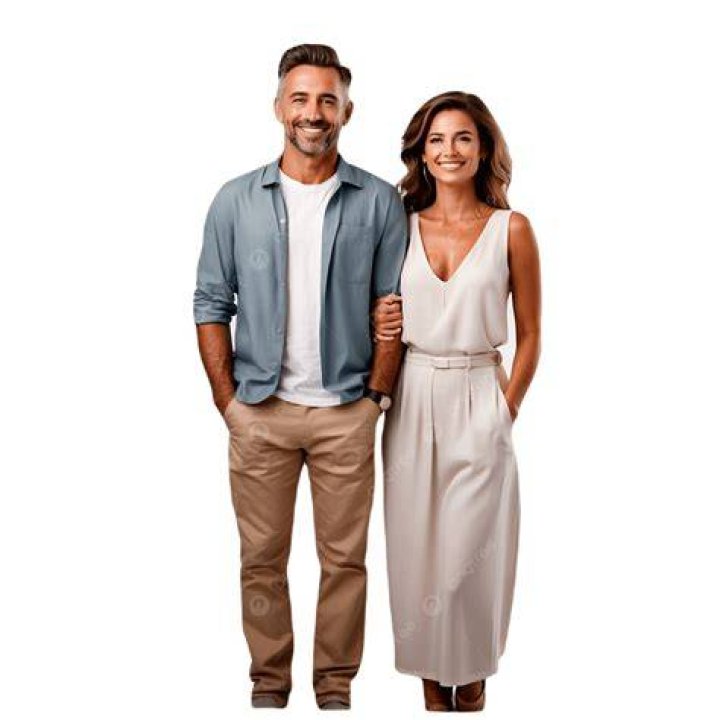a man and woman standing next to each other on a city street with