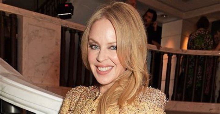 Kylie Minogue, 52, puts on a leggy display in clinging leather mini